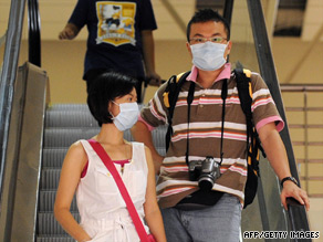 Travelers take precautions against the H1N1 virus in Kuala Lumpur.