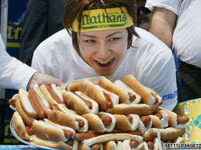 In last year's competition, Joey Chestnut celebrated his win and Kobayashi showed off his very full stomach.