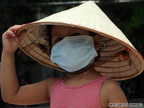 A young girl wears a mask at a hospital in Hanoi. Vietnam reported its first death from swine flu this week.