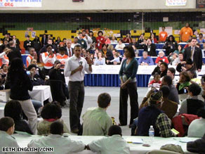 Obama, with his wife Michelle, addresses volunteers at a luncheon on Monday.