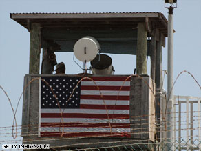 A guard keeps watch from a tower at the military facility at Guantanamo Bay, Cuba.