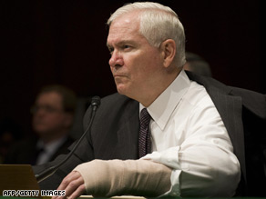 Robert Gates testifies Tuesday before a Senate panel. He was wearing bandages from surgery he had on his arm.