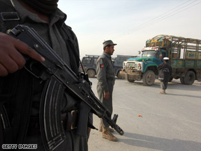 An Afghan policeman stands guard watching traffic at a checkpoint in Kabul, Afghanistan, Thursday.