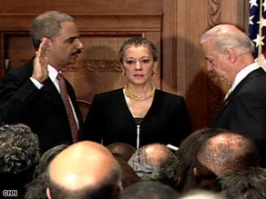 Vice President Joe Biden swears in Eric Holder, left, as attorney general Tuesday at the Justice Department.