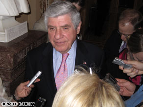 Republican Sen. Tom Coburn, right, of Oklahoma huddles with aides during negotiations Thursday evening.