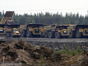 Trucks wait at an oil sands site in Alberta in 2007. Obama has environmental concerns about the sands.