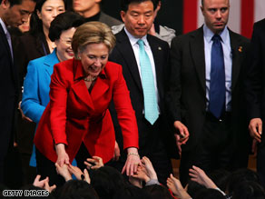 Secretary of State Hillary Clinton shakes hands with students Friday at a university in Seoul, South Korea.