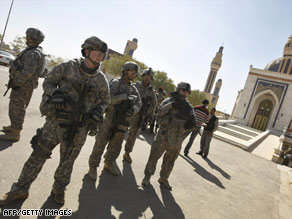 U.S. soldiers stand guard outside a mosque during a prisoner release Sunday in Baghdad, Iraq.