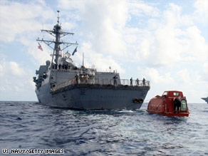 The USS Bainbridge tows the lifeboat in which Capt. Robert Phillips was held for days.