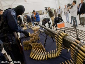 Mexican federal police officers this week display an arsenal seized near the U.S. border.