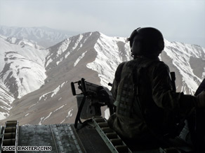 A U.S. soldier flies over Afghanistan aboard a Chinook helicopter in March.