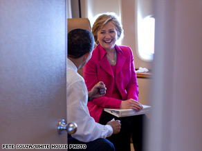 President Obama and Secretary of State Hillary Clinton share a conversation on board Air Force One.