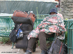 A homeless woman sits on a bench in Los Angeles, California.