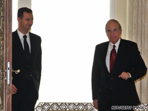 Syrian President Bashar al-Assad, left, welcomes U.S. envoy George Mitchell in Damascus on June 13.