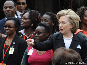 Hillary Clinton stands with survivors of the 1998 bombings of the U.S. Embassy in Nairobi in a ceremony Thursday.
