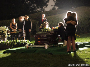 Sen Edward M. Kennedy's widow, Vicki, second from left, touches her husband's casket.