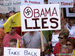 A protester uses a Nazi swastika to make a point at a Tea Party Express stop in Dallas, Texas.