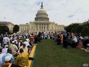 Muslims bow in prayer Friday at the event, which was meant to inspire American Muslims and non-Muslims.