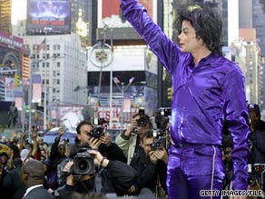Michael Jackson waves to a crowd of fans and photographers in New York's Times Square.