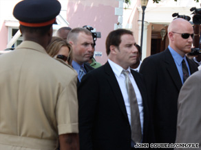John Travolta, center, and his wife, Kelly Preston, walk into court in the Bahamas in September.