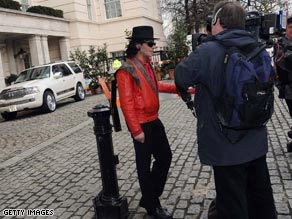A Michael Jackson impersonator is interviewed outside the London hotel where the singer is staying.