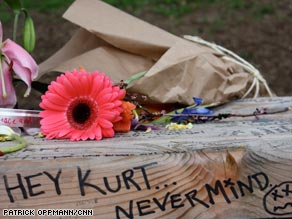 Fans leave flowers and mementos in honor of Kurt Cobain near his Seattle home.