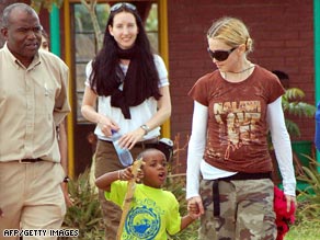 Madonna walks with her Malawian son, David Banda, in Lilongwe, Malawi, in March.