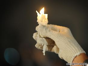 A gloved fan salutes Michael Jackson Thursday night outside UCLA Medical Center in Los Angeles, California.