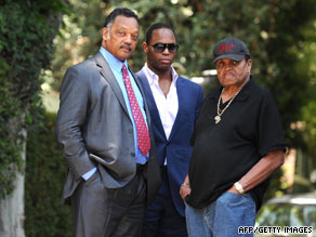 The Rev. Jesse Jackson, left, meets with Michael Jackson's father, Joe, right, and another man Friday.