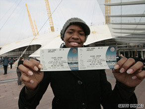 A fan shows off the first ticket bought at the O2 Centre in London for one of Michael Jackson's concerts.