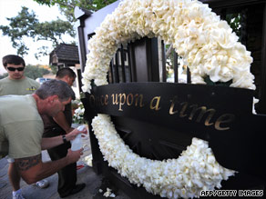 Workers fix the gate at Neverland Ranch's entrance this week in Los Olivos, California.