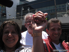 Barbara Ramirez, left, gives a Jackson memorial ticket to Melvin Price, right, because her husband cannot attend.
