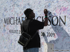 A fan leaves a note on a Michael Jackson memorial outside the Staples Center in Los Angeles.