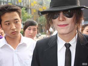 An eerily similar Michael Jackson impersonator performs for devotees in China Tuesday.
