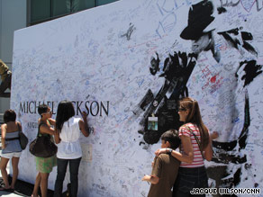 Fans sign a memorial wall for Michael Jackson this week near the Staples Center in Los Angeles, California.