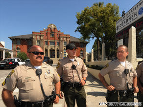 Police stand outside the Los Angeles County Coroner's Office when Michael Jackson's body was there in June.