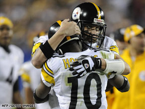 The Steelers' Santonio Holmes, in the 10 shirt, embraces another player.