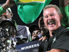 Stanford presents a trophy to the winners of his Twenty20 cricket tournament in November 2008.