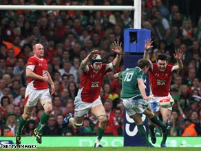 O'Driscoll lifts the Six Nations trophy after their grand slam triumph in Cardiff.