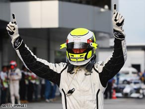 Button raises his arms in triumph after claiming pole for the second straight week.