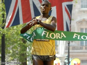 Wanjiru crosses the line in a personal best time to add the London Marathon title to his Olympic victory.