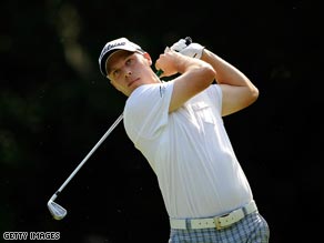 Crane plays his tee shot on the 8th at Sawgrass on the way to a 65.