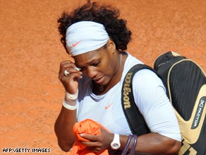 Serena Williams slips away after quitting her first round match at the Madrid Open through injury.