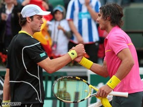 Perfect in pink. Nadal shakes hands with Gabashvili after his easy win.
