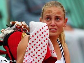 Jelena Dokic was left in tears after being forced to retire hurt against Elena Dementieva at the French Open.