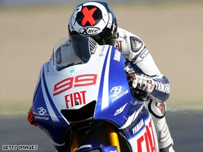 Lorenzo edged out world champion Valentino Rossi to take pole position for Sunday's Catalunya MotoGP.