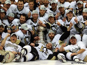 The Penguins celebrate with the Stanley Cup after claiming a narrow game seven victory at Detroit.