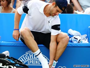 Andy Roddick feels his ankle injury before retiring from his semifinal against fellow-American James Blake.