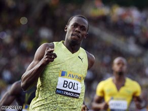 Bolt crosses the line in the 100m in London with Powell left trailing.