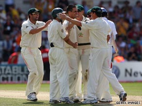 Mitchell Johnson is surrounded by his Australian team-mates after taking the wicket that won the fourth Test.